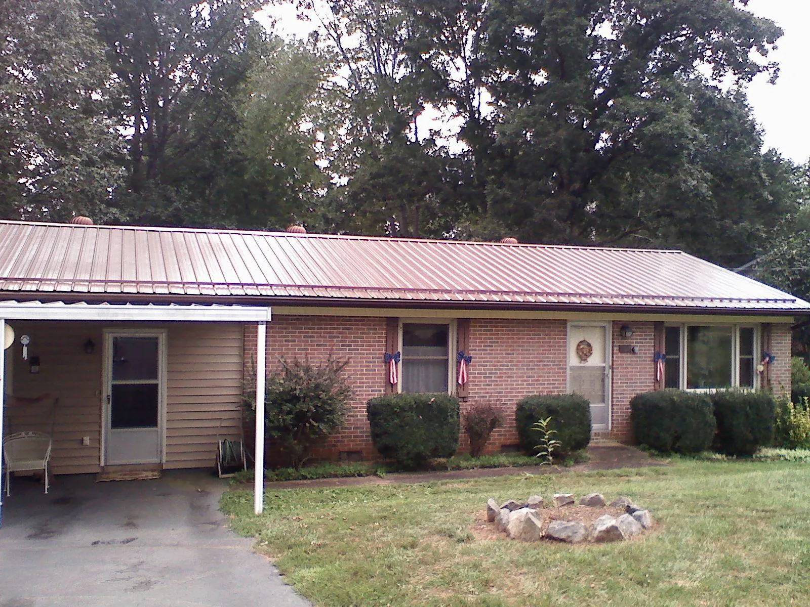Bronze metal roof and carport on a brick ranch home — Roof Repair work by our crew in Yulan
