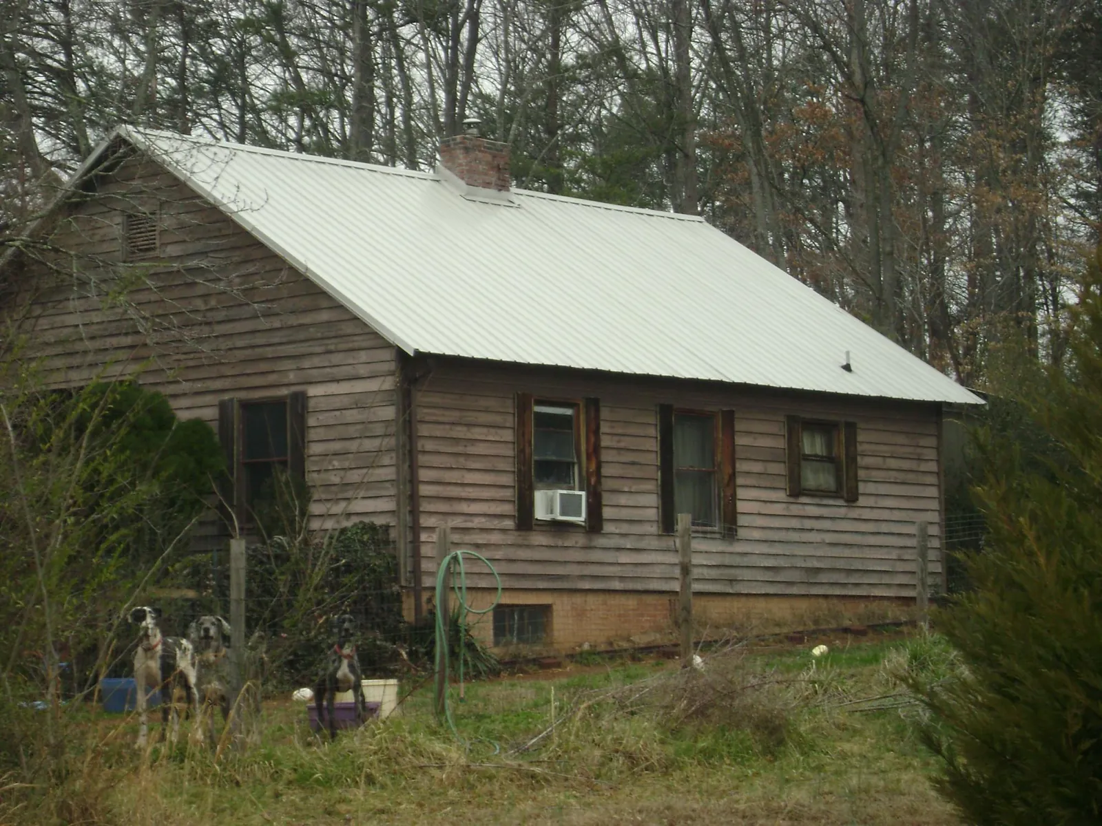 White metal roof on an old wood sided farmhouse, from a Metal Roof Installation job in Yulan